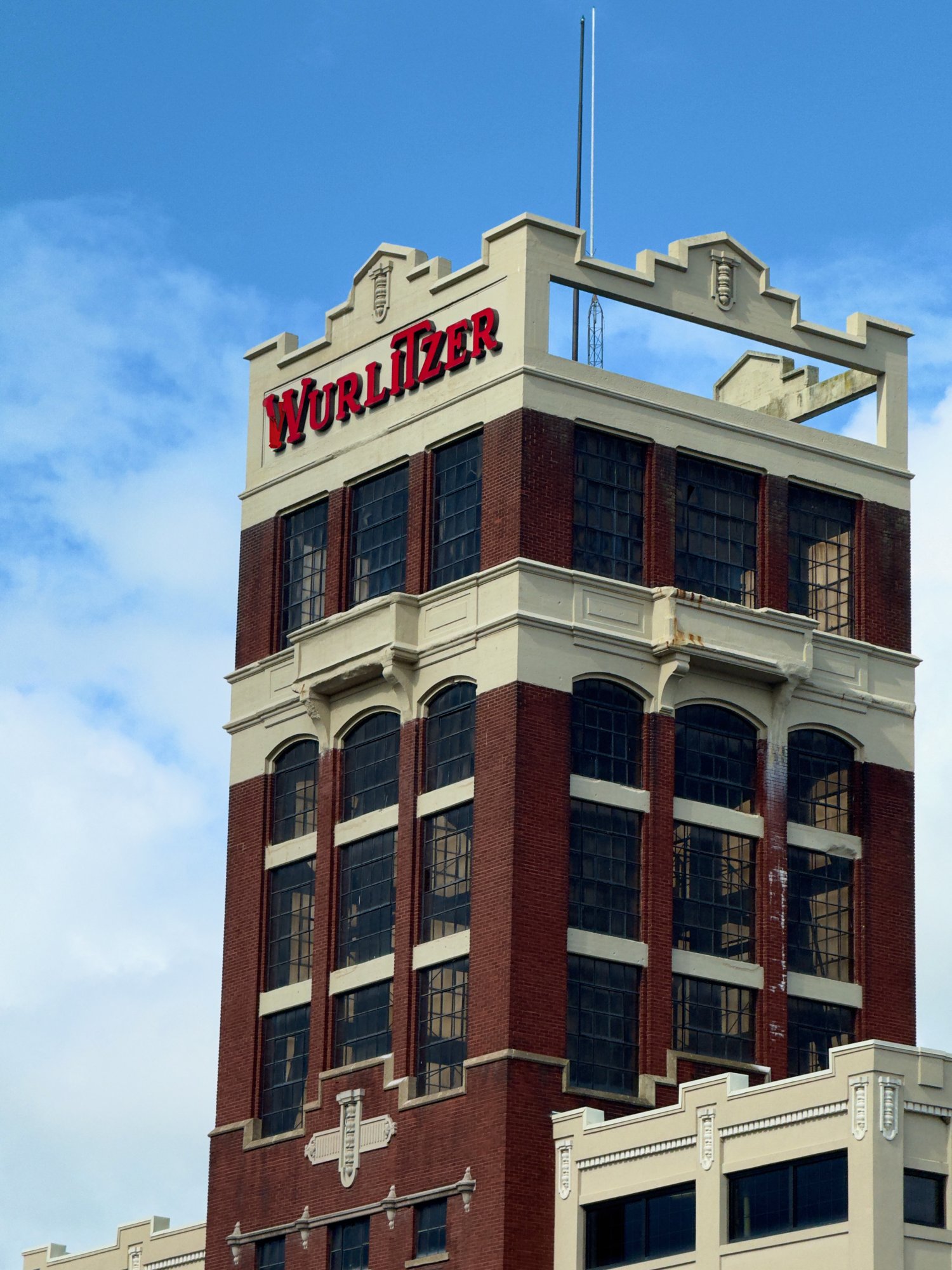 The Wurlitzer tower, brickwork, tall windows and restored rooftop lettering